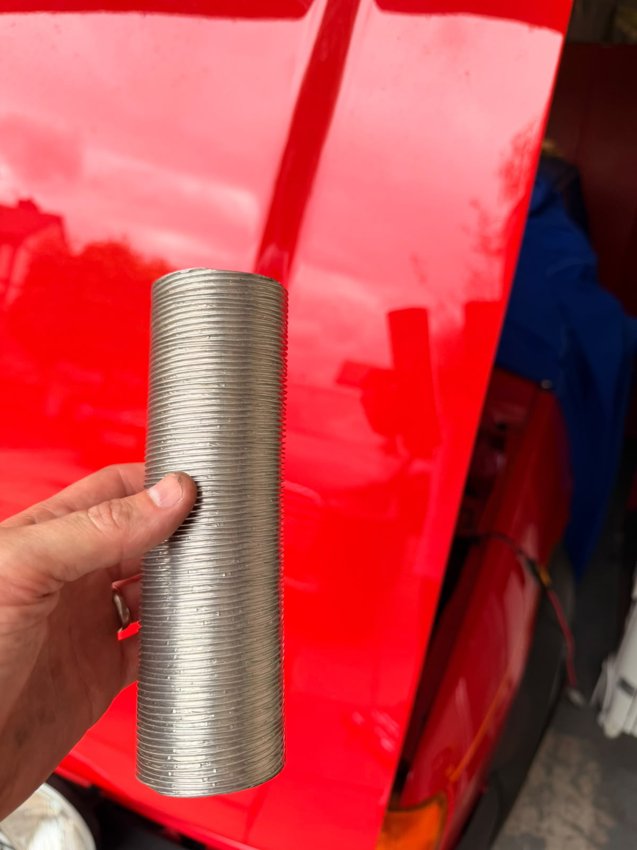 A length of flexible hose held alongside the bodywork.